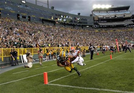 Green Bay Packers' Jordy Nelson (L) scores a touchdown against the defense of Cleveland Browns' Joe Haden (R) in the first half during their Green Bay Packers' Jordy Nelson (L) scores a touchdown against the defense of Cleveland Browns' Joe Haden (R) in the first half during their