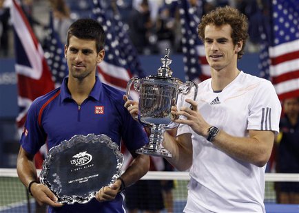 Britain's Andy Murray (R) and Serbia's Novak Djokovic hold their trophies after Murray defeated Djokovic in the men's singles final match at Britain's Andy Murray (R) and Serbia's Novak Djokovic hold their trophies after Murray defeated Djokovic in the men's singles final match at