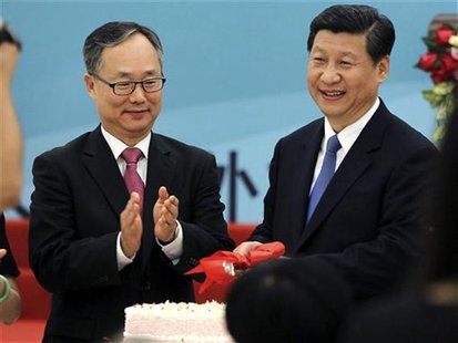Chinese Vice President Xi Jinping (R) and the Republic of Korea (ROK)'s Ambassador to China, Lee Kyu-hyung (L), cut a cake at a reception to Chinese Vice President Xi Jinping (R) and the Republic of Korea (ROK)'s Ambassador to China, Lee Kyu-hyung (L), cut a cake at a reception to