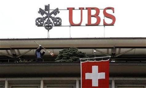 A Switzerland national flag flies in front of the logo of Swiss bank UBS at the company's headquarters in Zurich April 13, 2012. REUTERS/Arn A Switzerland national flag flies in front of the logo of Swiss bank UBS at the company's headquarters in Zurich April 13, 2012. REUTERS/Arn
