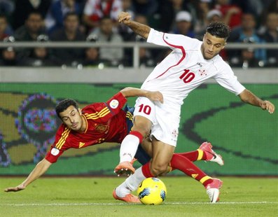 Spain's Pedro Rodriguez (L) struggles for the ball with Georgia's Tornike Okriashvili during their 2014 World Cup qualifying soccer match at Spain's Pedro Rodriguez (L) struggles for the ball with Georgia's Tornike Okriashvili during their 2014 World Cup qualifying soccer match at