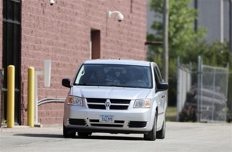A Dodge Caravan carrying Russell Wasendorf Sr. exits from the back entrance of the United States Federal Court of the Northern District of I A Dodge Caravan carrying Russell Wasendorf Sr. exits from the back entrance of the United States Federal Court of the Northern District of I