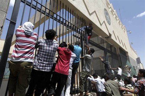Protesters climb a fence surrounding the U.S. embassy in Sanaa September 13, 2012. REUTERS/Mohamed al-Sayaghi Protesters climb a fence surrounding the U.S. embassy in Sanaa September 13, 2012. REUTERS/Mohamed al-Sayaghi