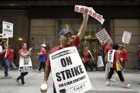 Chicago Teachers Union member and Math teacher Henry Pera pickets outside the CPS headquarters in Chicago on the fourth day of their strike, Chicago Teachers Union member and Math teacher Henry Pera pickets outside the CPS headquarters in Chicago on the fourth day of their strike,