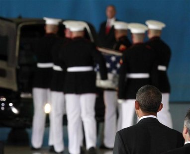 U.S. President Barack Obama watches as the body of an American killed in Benghazi this week is placed in a hearse during a return of remains U.S. President Barack Obama watches as the body of an American killed in Benghazi this week is placed in a hearse during a return of remains