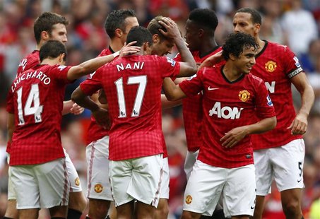 Manchester United's Nick Powell (4th R) celebrates his goal against Wigan Athletic with team mates during their English Premier League socce Manchester United's Nick Powell (4th R) celebrates his goal against Wigan Athletic with team mates during their English Premier League socce