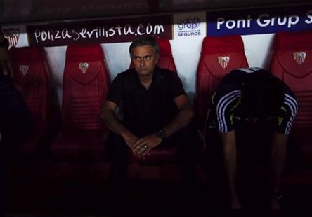 Real Madrid's coach Jose Mourinho sits before the start their Spanish First Division soccer match against Sevilla at Ramon Sanchez Pizjuan s Real Madrid's coach Jose Mourinho sits before the start their Spanish First Division soccer match against Sevilla at Ramon Sanchez Pizjuan s