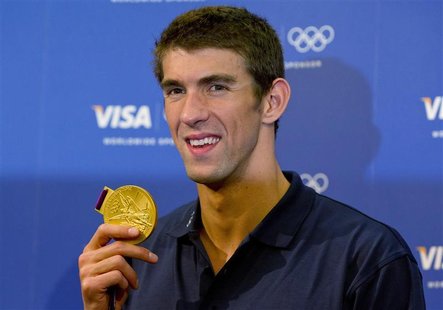 U.S. swimmer Michael Phelps poses with his gold medal for the 4x100m medley relay during a news conference with his sponsors at the London 2 U.S. swimmer Michael Phelps poses with his gold medal for the 4x100m medley relay during a news conference with his sponsors at the London 2