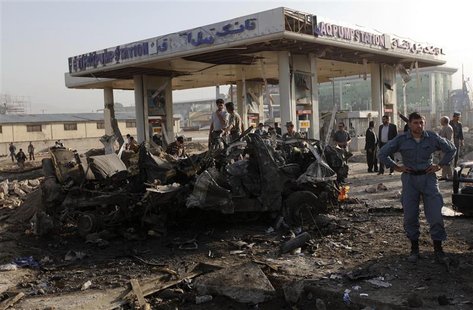 Afghan security personnel investigate at the site of a suicide attack in Kabul September 18, 2012. A suicide bomber blew up a mini-bus carry Afghan security personnel investigate at the site of a suicide attack in Kabul September 18, 2012. A suicide bomber blew up a mini-bus carry