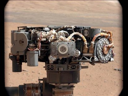 In this image taken by Curiosity's Mast Camera, the Alpha Particle X-Ray Spectrometer (APXS) on NASA's Curiosity rover is pictured, with the In this image taken by Curiosity's Mast Camera, the Alpha Particle X-Ray Spectrometer (APXS) on NASA's Curiosity rover is pictured, with the
