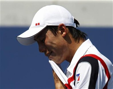 Kei Nishikori of Japan pauses during play against Marin Cilic of Croatia during their men's singles match at the U.S. Open tennis tournament Kei Nishikori of Japan pauses during play against Marin Cilic of Croatia during their men's singles match at the U.S. Open tennis tournament