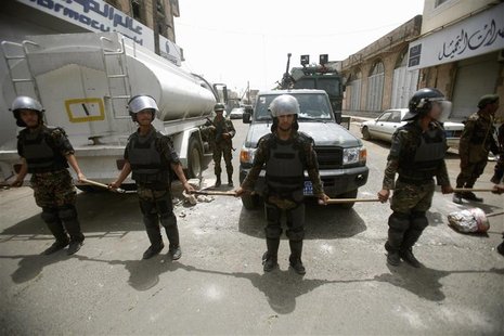 Riot policemen stand guard outside the French embassy in Sanaa September 20, 2012. REUTERS/Khaled Abdullah Riot policemen stand guard outside the French embassy in Sanaa September 20, 2012. REUTERS/Khaled Abdullah