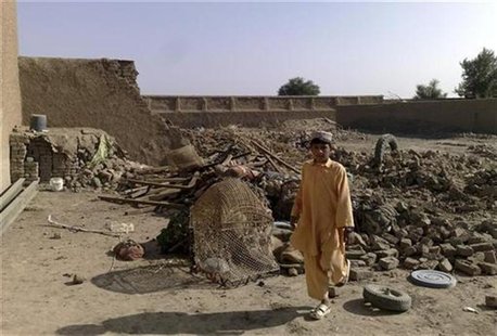 A boy stands at the site of suspected U.S. drone attacks in the Janikhel tribal area in Bannu district of North West Frontier Province Novem A boy stands at the site of suspected U.S. drone attacks in the Janikhel tribal area in Bannu district of North West Frontier Province Novem