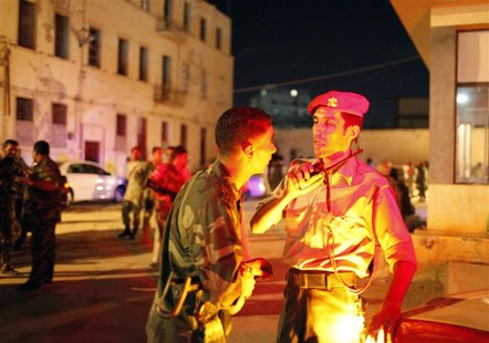 Army members talk as they check an armed militia base they stormed with pro-government demonstrators in Benghazi September 21, 2012. Libyan Army members talk as they check an armed militia base they stormed with pro-government demonstrators in Benghazi September 21, 2012. Libyan