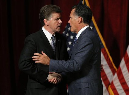 Republican presidential candidate and former Massachusetts Governor Mitt Romney (R) shakes hands with talk radio host Mark Larson at a campa Republican presidential candidate and former Massachusetts Governor Mitt Romney (R) shakes hands with talk radio host Mark Larson at a campa