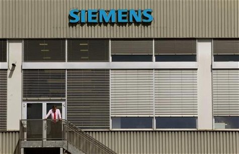 A man stands in front of a building of Siemens Schweiz AG Building Technologies Group, a Swiss unit of German Siemens AG in the central Swis A man stands in front of a building of Siemens Schweiz AG Building Technologies Group, a Swiss unit of German Siemens AG in the central Swis