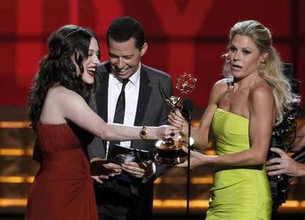 Presenters Kat Dennings and Jon Cryer hand out the award for outstanding supporting actress in a comedy series to Julie Bowen (R) for "Moder Presenters Kat Dennings and Jon Cryer hand out the award for outstanding supporting actress in a comedy series to Julie Bowen (R) for "Moder