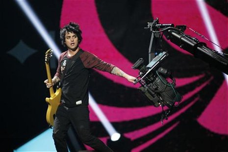 Green Day lead vocalist and guitarist Billie Joe Armstrong grabs a camera during the 2012 iHeart Radio Music Festival at the MGM Grand Garde Green Day lead vocalist and guitarist Billie Joe Armstrong grabs a camera during the 2012 iHeart Radio Music Festival at the MGM Grand Garde