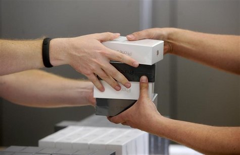 An Apple employee distributes iPhone 5 shortly after the device went on sale in San Francisco, California, September 21, 2012. REUTERS/Noah An Apple employee distributes iPhone 5 shortly after the device went on sale in San Francisco, California, September 21, 2012. REUTERS/Noah