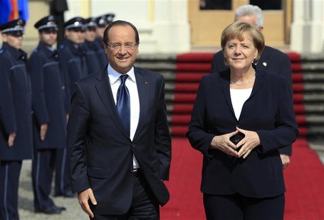 France's President Francois Hollande (L) and Germany's Chancellor Angela Merkel arrive for the 50th anniversary ceremony of the reconciliati France's President Francois Hollande (L) and Germany's Chancellor Angela Merkel arrive for the 50th anniversary ceremony of the reconciliati