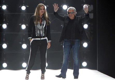 Italian designer Roberto Cavalli and his wife Eva acknowledge applause on the catwalk at the end of his Spring/Summer 2013 collection at Mil Italian designer Roberto Cavalli and his wife Eva acknowledge applause on the catwalk at the end of his Spring/Summer 2013 collection at Mil