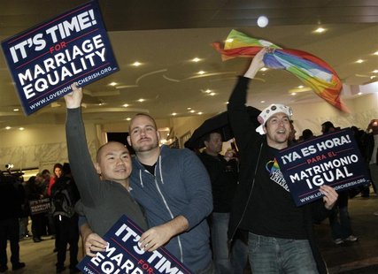 Pakki Hui, Jon Scaggs, and Steve Scott hold placards at a rally celebrating Tuesday's ruling on Proposition 8 in West Hollywood, California, Pakki Hui, Jon Scaggs, and Steve Scott hold placards at a rally celebrating Tuesday's ruling on Proposition 8 in West Hollywood, California,