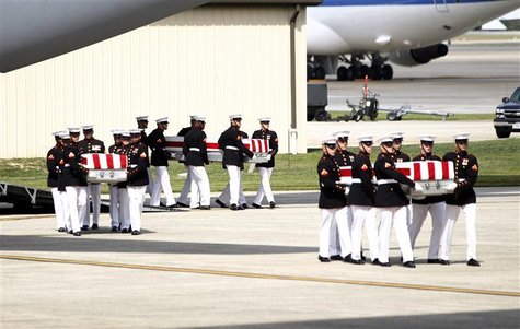 The remains of the U.S. ambassador and three other Americans killed in an attack in Libya are taken off a transport aircraft during a return The remains of the U.S. ambassador and three other Americans killed in an attack in Libya are taken off a transport aircraft during a return
