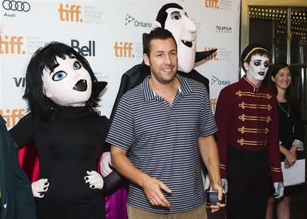 Actor Adam Sandler poses with mascots of characters from "Hotel Transylvania", as he arrives on the red carpet for the film's gala presentat Actor Adam Sandler poses with mascots of characters from "Hotel Transylvania", as he arrives on the red carpet for the film's gala presentat