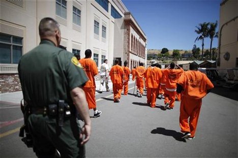 Inmates are escorted by a guard through San Quentin state prison in San Quentin, California, June 8, 2012. REUTERS/Lucy Nicholson Inmates are escorted by a guard through San Quentin state prison in San Quentin, California, June 8, 2012. REUTERS/Lucy Nicholson