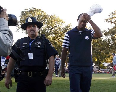U.S. golfer Tiger Woods leaves the 18th green after halving his match against Team Europe golfer Francesco Molinari of Italy during the 39th U.S. golfer Tiger Woods leaves the 18th green after halving his match against Team Europe golfer Francesco Molinari of Italy during the 39th