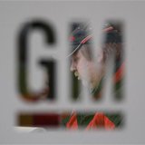A worker walks behind a logo of General Motors after the announcement of the closing of the Opel assembly plant in Antwerp January 21, 2010. A worker walks behind a logo of General Motors after the announcement of the closing of the Opel assembly plant in Antwerp January 21, 2010.