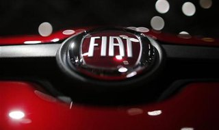 A company logo is seen on a Fiat car displayed on media day at the Paris Mondial de l'Automobile, September 28, 2012. The Paris auto show op