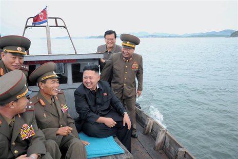 North Korean leader Kim Jong-Un (C) sits in a wooden boat with other soldiers as he visits military units on islands in the most southwest o North Korean leader Kim Jong-Un (C) sits in a wooden boat with other soldiers as he visits military units on islands in the most southwest o