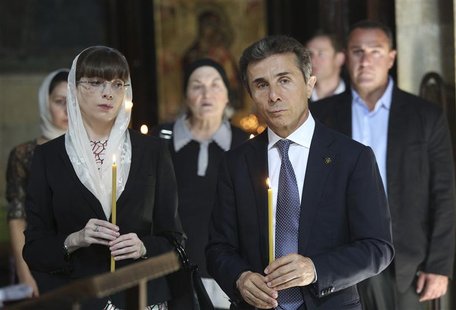 Leader of the opposition Georgian Dream coalition Bidzina Ivanishvili (R) and his wife Eka Khvedelidze attend a religious service in Tbilisi Leader of the opposition Georgian Dream coalition Bidzina Ivanishvili (R) and his wife Eka Khvedelidze attend a religious service in Tbilisi