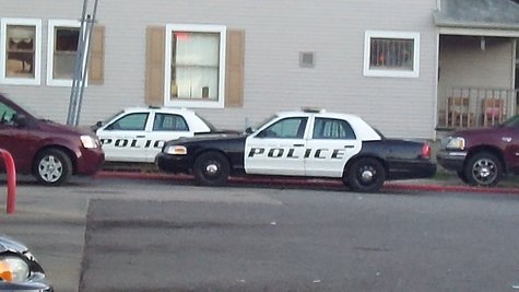 Officers interviewing the neighbors. Officers interviewing the neighbors.