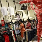 People shop for clothes at a store during a seasonal sale inside a shopping mall in Mumbai July 14, 2012. REUTERS/Danish Siddiqui