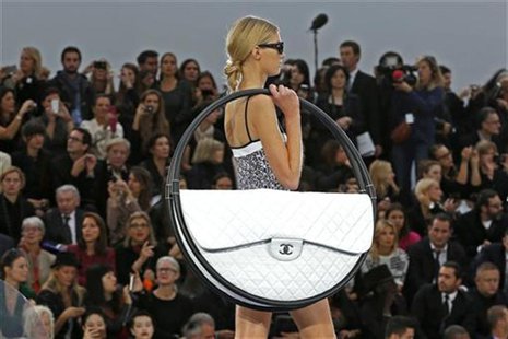 A model presents a creation by German designer Karl Lagerfeld for French fashion house Chanel as part of his Spring/Summer 2013 women's read A model presents a creation by German designer Karl Lagerfeld for French fashion house Chanel as part of his Spring/Summer 2013 women's read