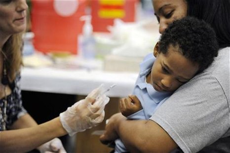 A child reacts as he receives the H1N1 swine flu vaccine in a nasal spray at Dodge Park Elementary School in Landover, Maryland, October 9, A child reacts as he receives the H1N1 swine flu vaccine in a nasal spray at Dodge Park Elementary School in Landover, Maryland, October 9,