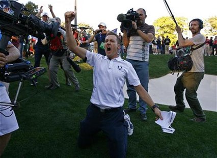 Team Europe golfer Ian Poulter of England celebrates winning the Ryder Cup for Europe during the 39th Ryder Cup singles golf matches at the Team Europe golfer Ian Poulter of England celebrates winning the Ryder Cup for Europe during the 39th Ryder Cup singles golf matches at the