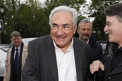 Former IMF head Dominique Strauss-Kahn (C) and Francois Pupponi (2ndR), Deputy Mayor of Sarcelles arrive at a polling station in the second Former IMF head Dominique Strauss-Kahn (C) and Francois Pupponi (2ndR), Deputy Mayor of Sarcelles arrive at a polling station in the second