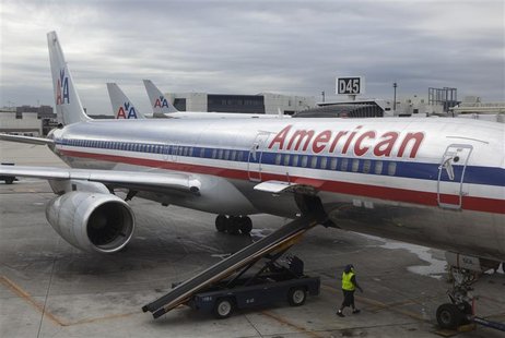 A worker walks underneath an American Airlines airplane at Miami International airport in Miami, Florida in this November 29, 2011, file pho A worker walks underneath an American Airlines airplane at Miami International airport in Miami, Florida in this November 29, 2011, file pho