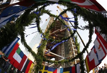 The topping out wreath carrying the flags of the 27 EU member states is lifted up during the topping out ceremony at the construction site o The topping out wreath carrying the flags of the 27 EU member states is lifted up during the topping out ceremony at the construction site o