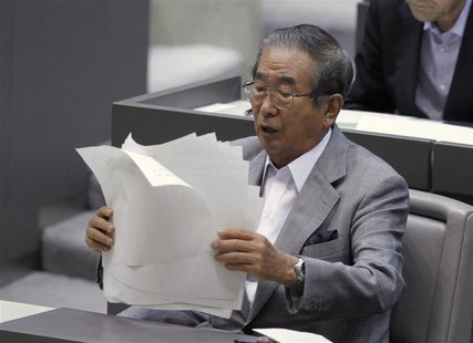 Tokyo Governor Shintaro Ishihara organises his documents after delivering a policy speech about the territorial dispute over the uninhabited Tokyo Governor Shintaro Ishihara organises his documents after delivering a policy speech about the territorial dispute over the uninhabited