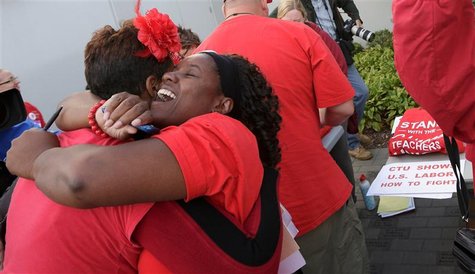 Jacqueline Robinson (R) hugs another member of the Chicago Teachers Union as they celebrate the end of their strike in Chicago September 18, Jacqueline Robinson (R) hugs another member of the Chicago Teachers Union as they celebrate the end of their strike in Chicago September 18,