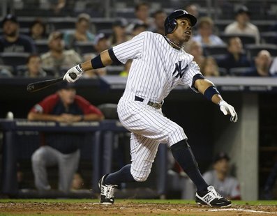 New York Yankees batter Curtis Granderson follows through his swing as he hits a three-run home run against the Boston Red Sox in the second New York Yankees batter Curtis Granderson follows through his swing as he hits a three-run home run against the Boston Red Sox in the second