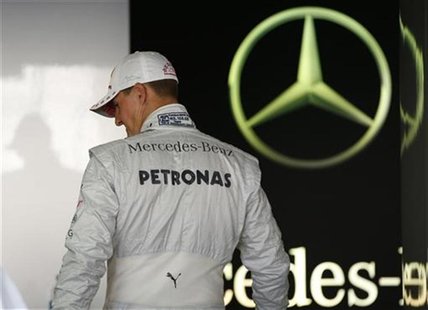 Mercedes Formula One driver Michael Schumacher of Germany walks in his garage at the Suzuka circuit October 4, 2012, ahead of Sunday's Japan Mercedes Formula One driver Michael Schumacher of Germany walks in his garage at the Suzuka circuit October 4, 2012, ahead of Sunday's Japan