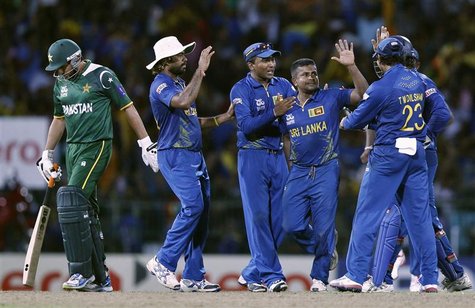 Sri Lanka's Rangana Herath (2nd R) celebrates with his teammates after he took the wicket of Pakistan's Shahid Afridi (L) during their Twent Sri Lanka's Rangana Herath (2nd R) celebrates with his teammates after he took the wicket of Pakistan's Shahid Afridi (L) during their Twent