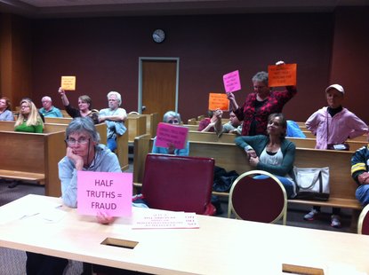 The remaining opposition to the facility hold signs up as they realize the committee was going to vote to keep the of the permit in place Wednesday night. The remaining opposition to the facility hold signs up as they realize the committee was going to vote to keep the of the permit in place Wednesday night.