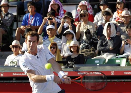 Andy Murray of Britain returns a shot to Stanislas Wawrinka of Switzerland in front of spectators shielding from the sun during their men's Andy Murray of Britain returns a shot to Stanislas Wawrinka of Switzerland in front of spectators shielding from the sun during their men's