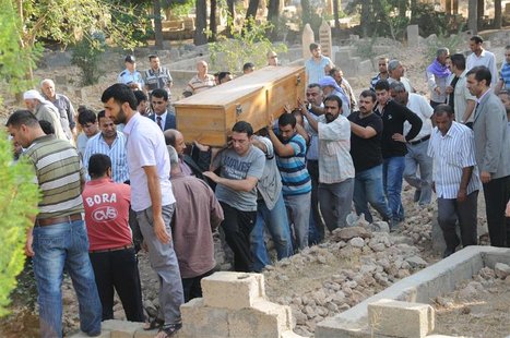 Relatives carry the coffin of a victim who was killed by a mortar bomb, during a funeral procession at a cemetery in the border town of Akca Relatives carry the coffin of a victim who was killed by a mortar bomb, during a funeral procession at a cemetery in the border town of Akca
